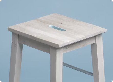 Wooden stool on light blue background