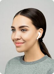 Woman wearing wireless earbuds smiling