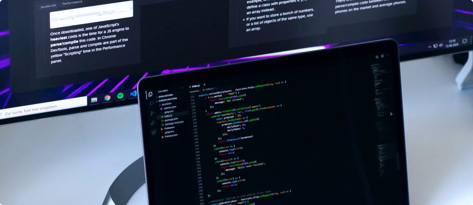Computer screens displaying coding software.