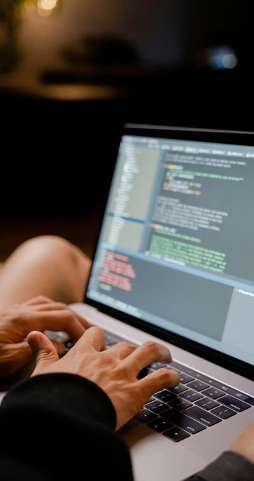 Person typing code on a laptop computer