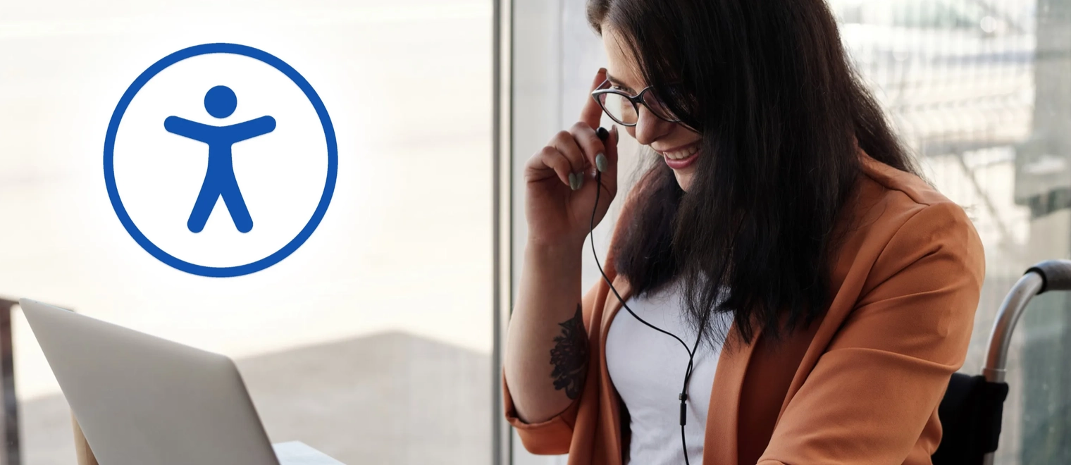 Woman in wheelchair using laptop and headset