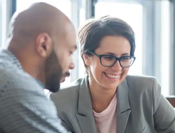 Professionals discussing work in a bright office