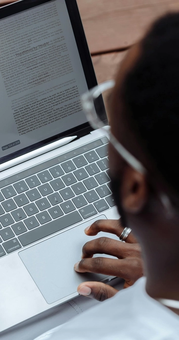 Person reading document on a laptop screen