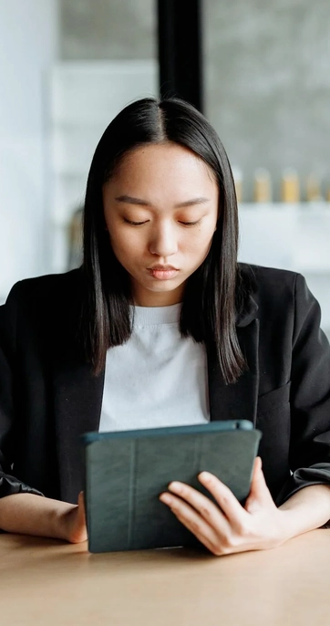 Woman reading tablet in modern office setting