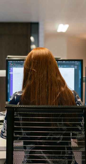 Woman working on computer in office.