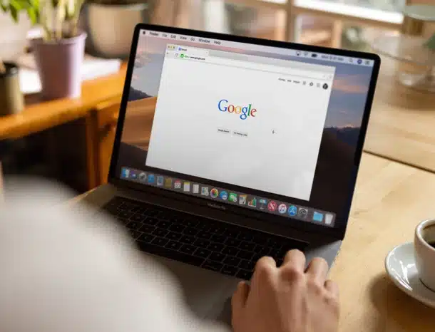 Person browsing Google on a laptop computer