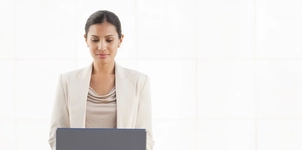 Businesswoman working on laptop in office environment
