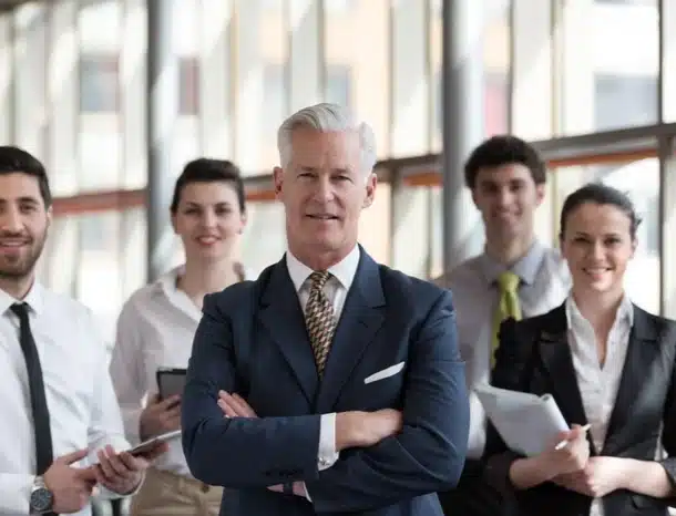 Business team posing confidently in office environment.